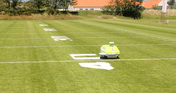 Turf tank robot painting numbers on a football field