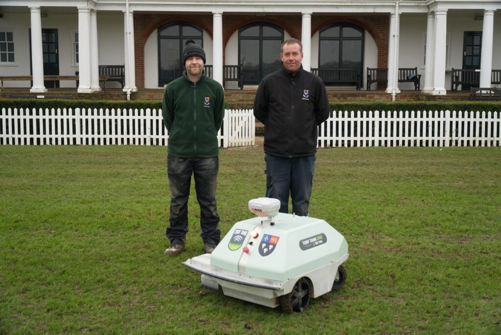 Turf Tank Customers posing for at picture with their new autonomous line marking robot