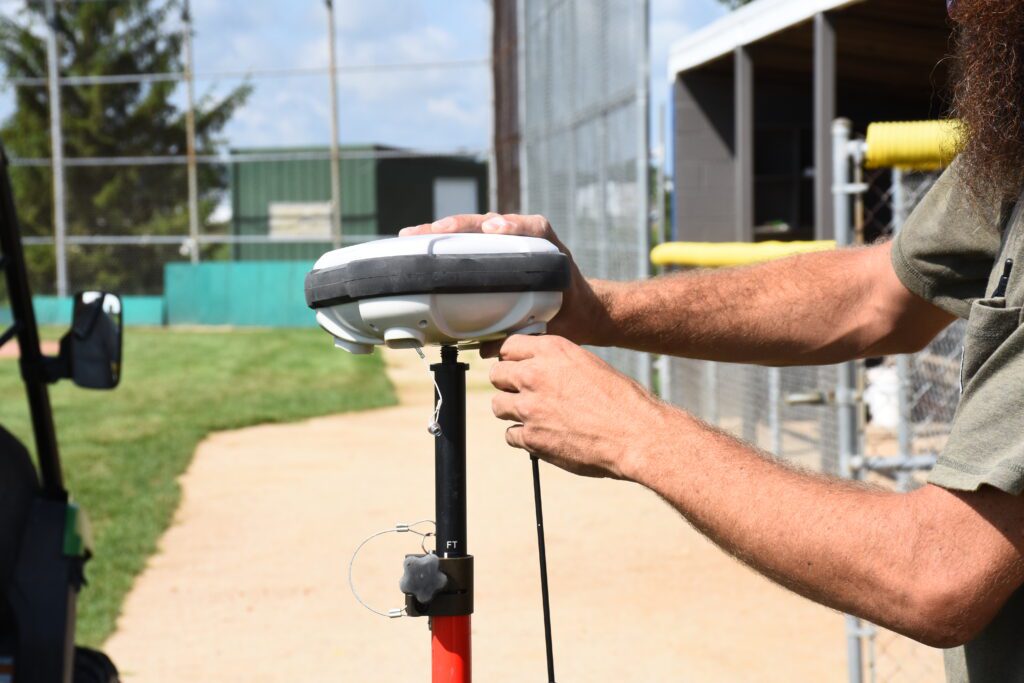 Guy with big beard setting up an Turf Tank base station