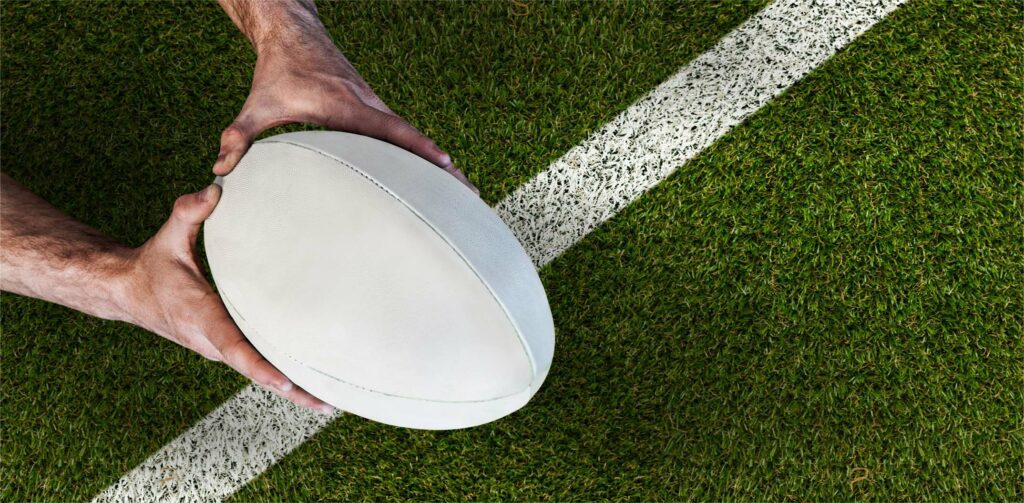 Rugby ball barely crossing a white line