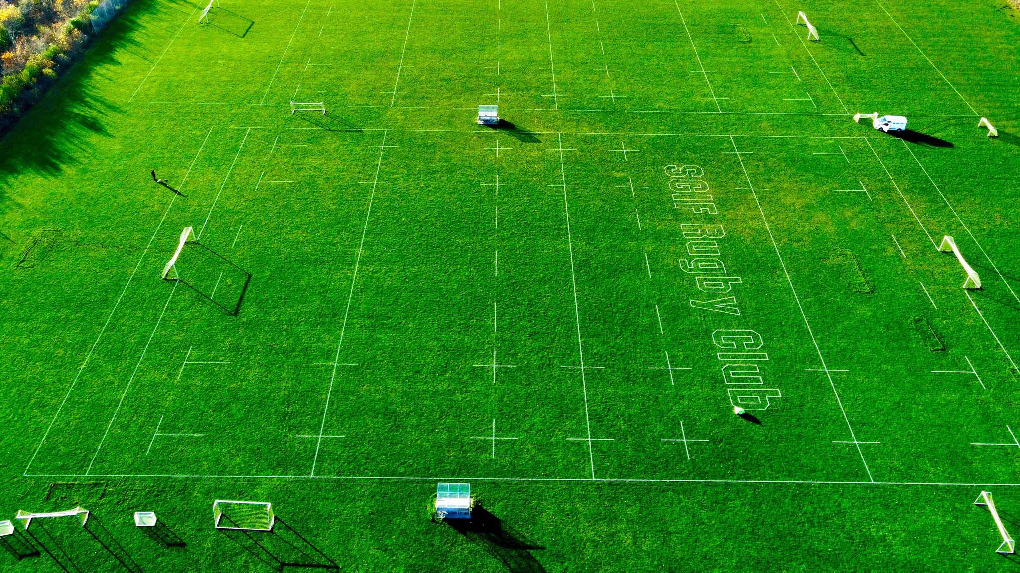 SGIF rugby club's field being painted with their logo in the middle by a Turf Tank one plus robot