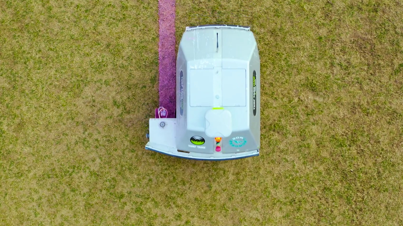 Bird view picture of Turf Tank robot painting a straight pink line