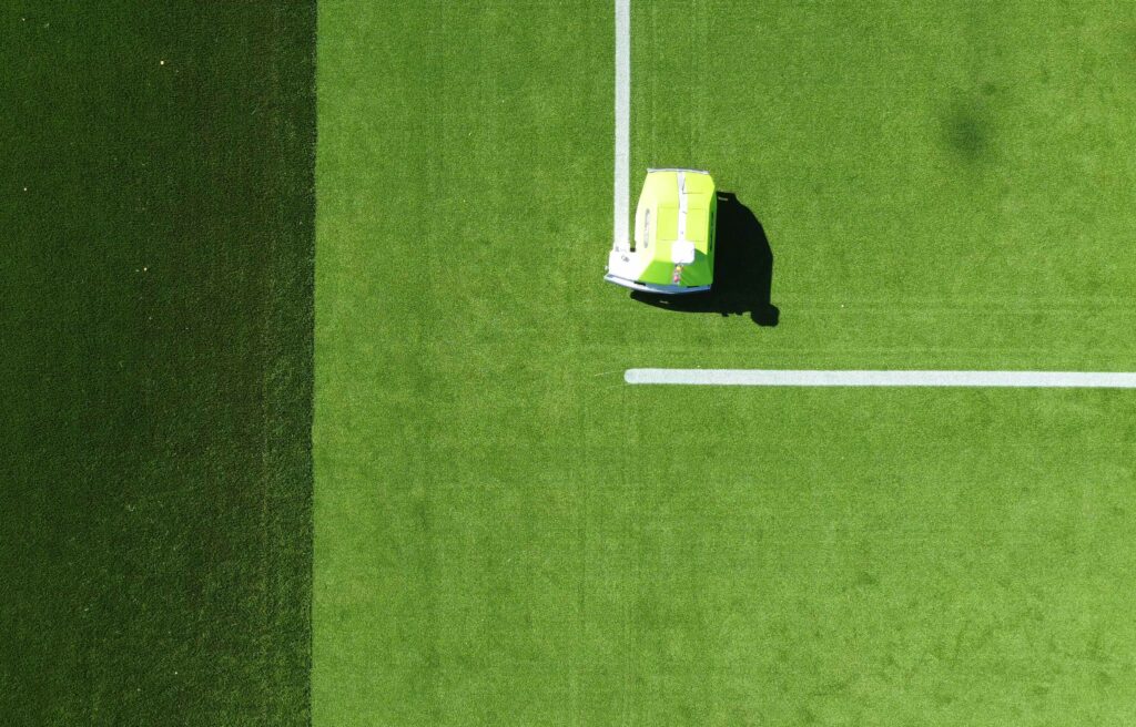Corner line on an artificial soccer field being painted by autonomous line marking robot, Turf Tank