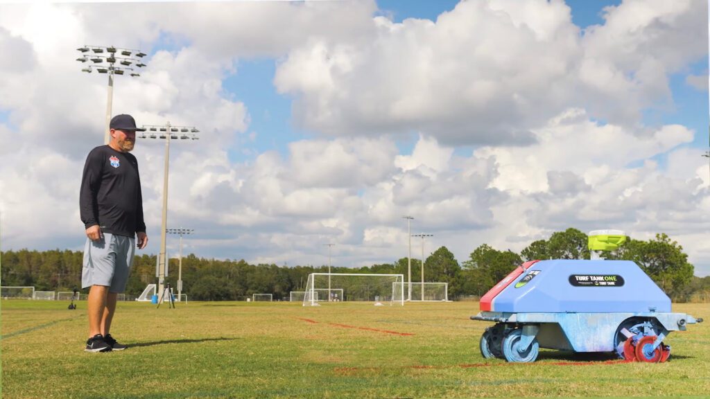 Tampa bay united's custom wrapped line marking robot painting a field