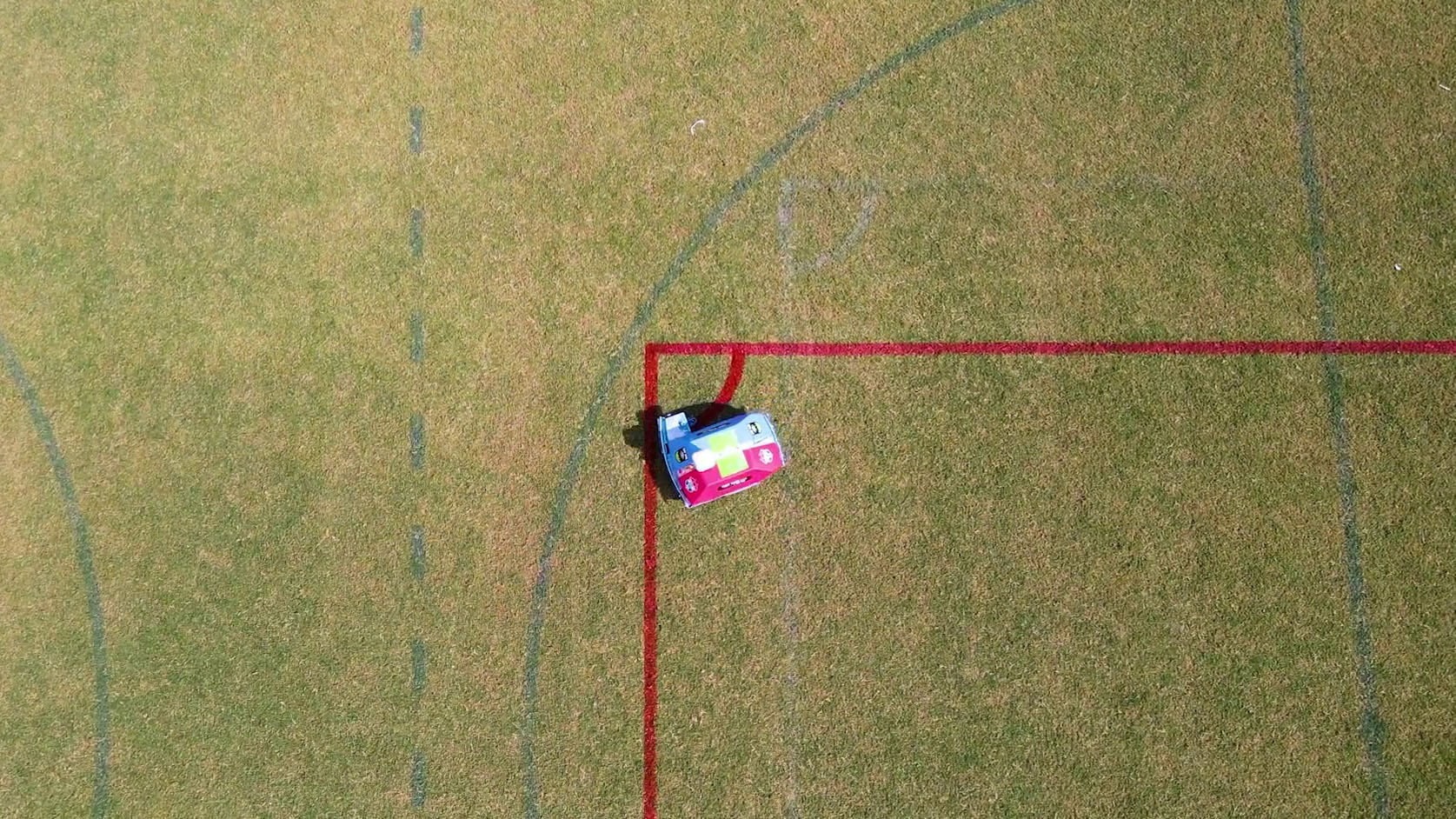 Custom wrapped line marking robot painting the corner arc on a soccer field