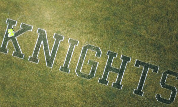 Knights text on grass painted by turf tank robot
