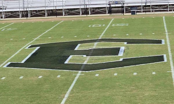 large custom logo painted on field by turf tank robot