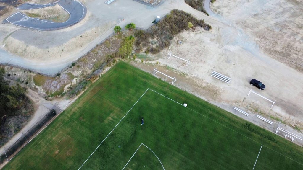 Drone picture of autonomous line marking robot painting a field in Chula Vista
