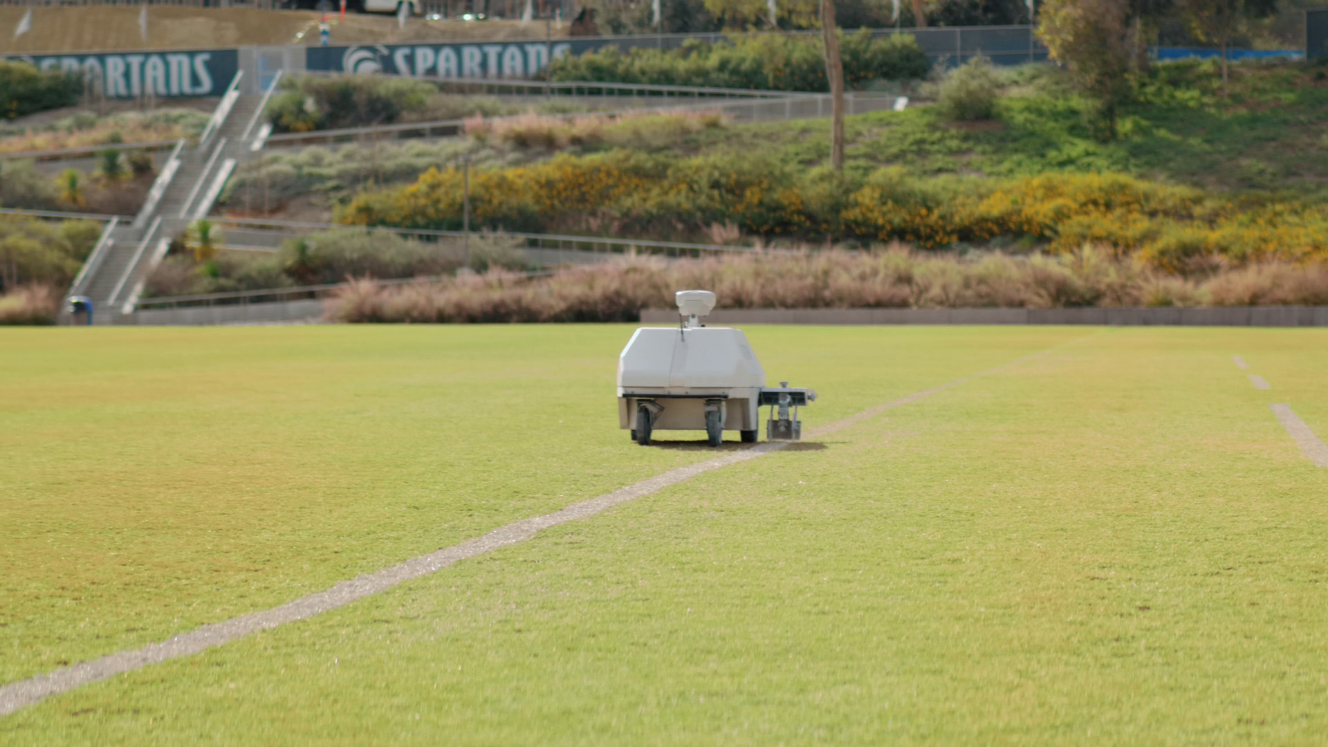 Miracostas autonomous line marking robot called Turf Tank painting a straight line