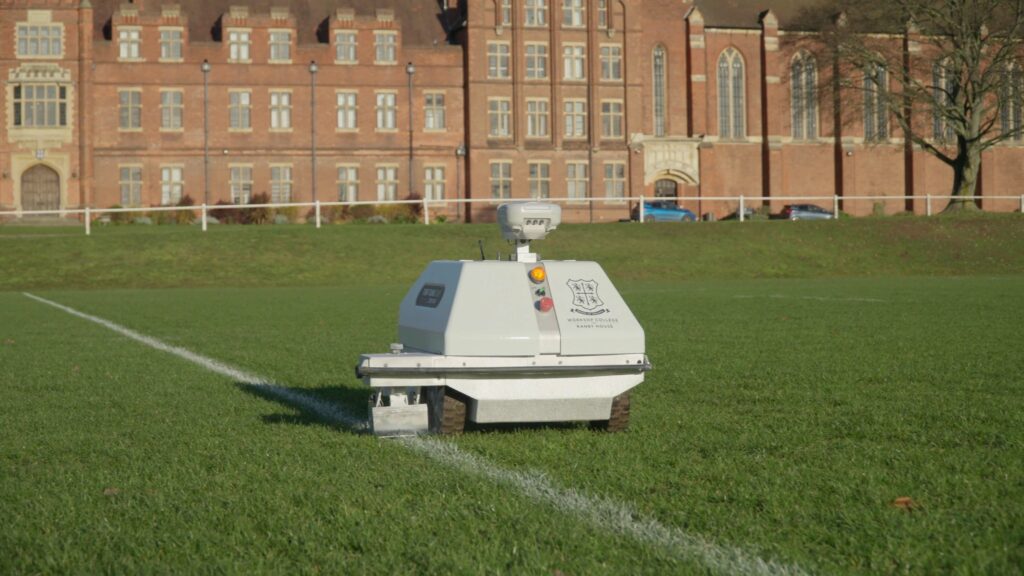 Workshop college's autonomous line marking robot Turf Tank painting a straight line