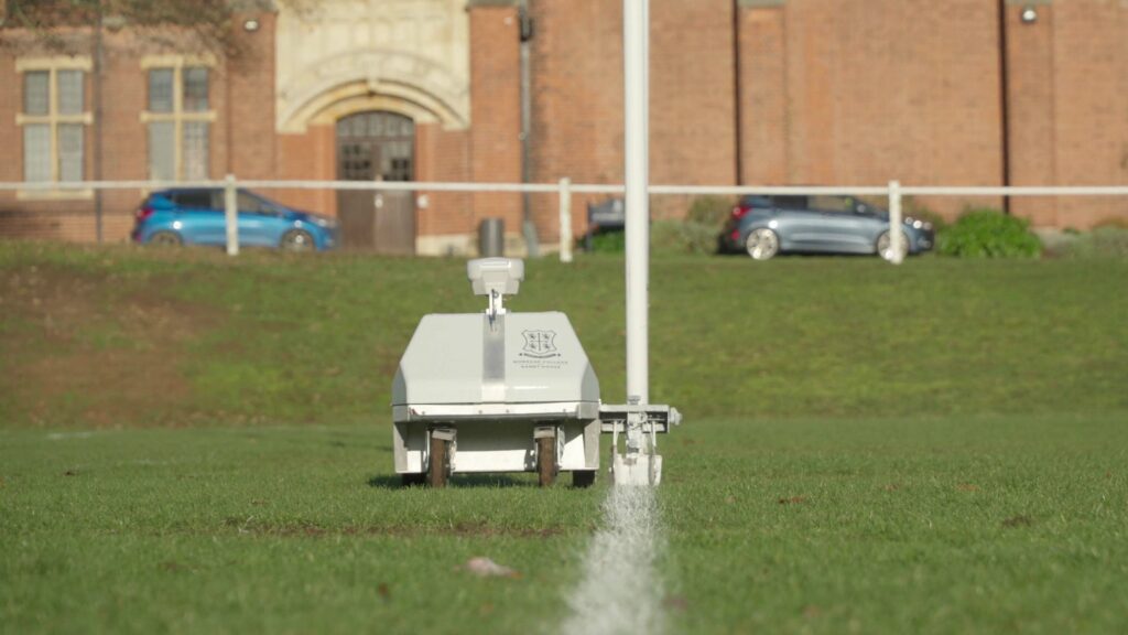 Turf tank autonomous line marking robot painting a straight field