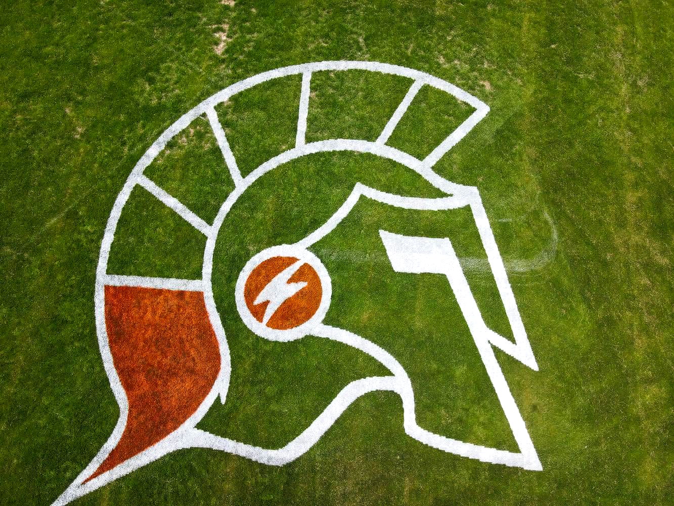 Michigan Trojans logo painted by autonomous line marking robot Turf Tank