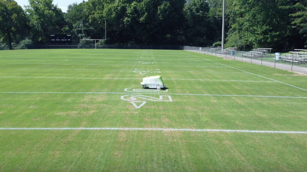 Line marking robot painting numbers on a football field