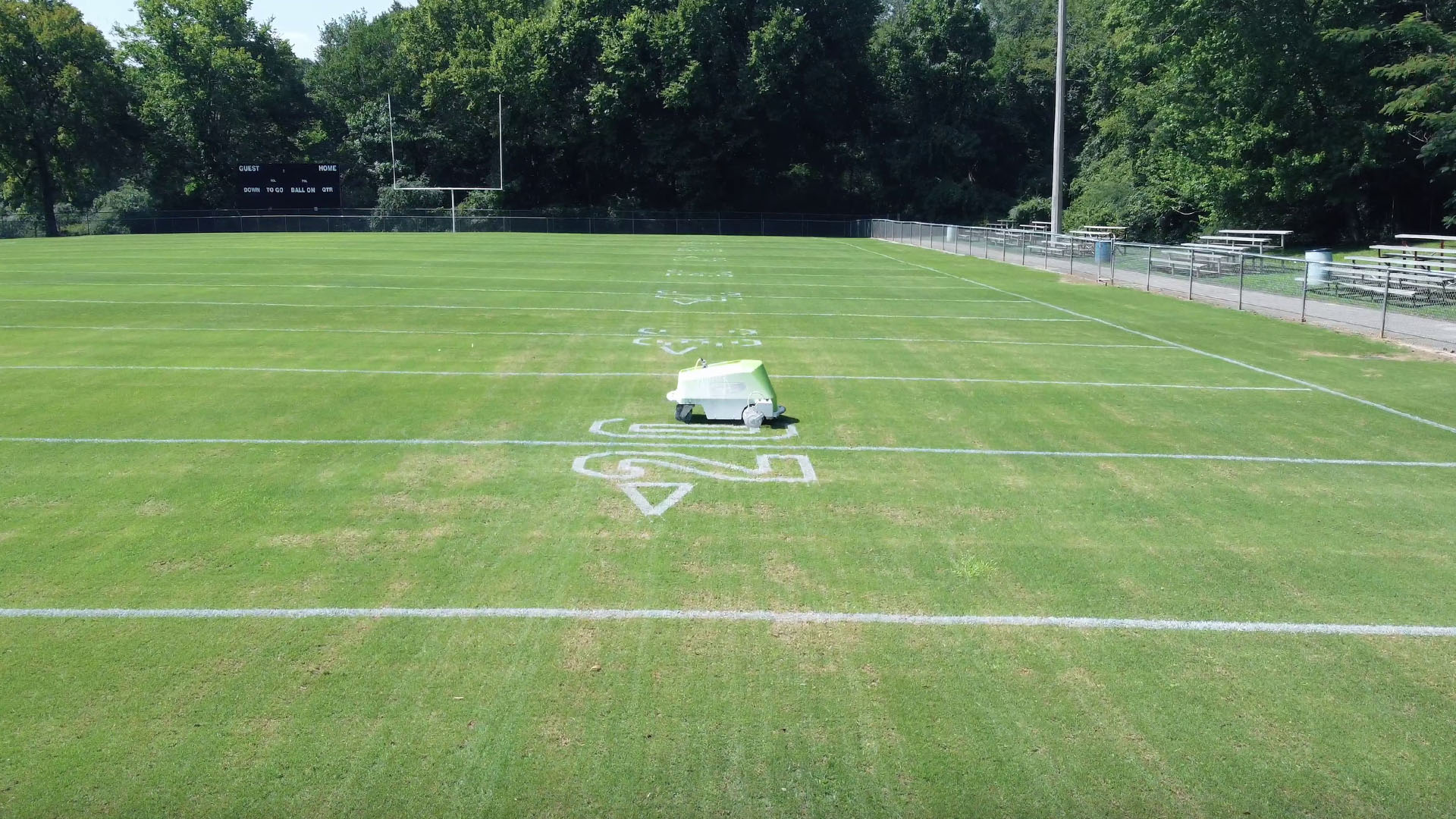 Line marking robot painting numbers on a football field